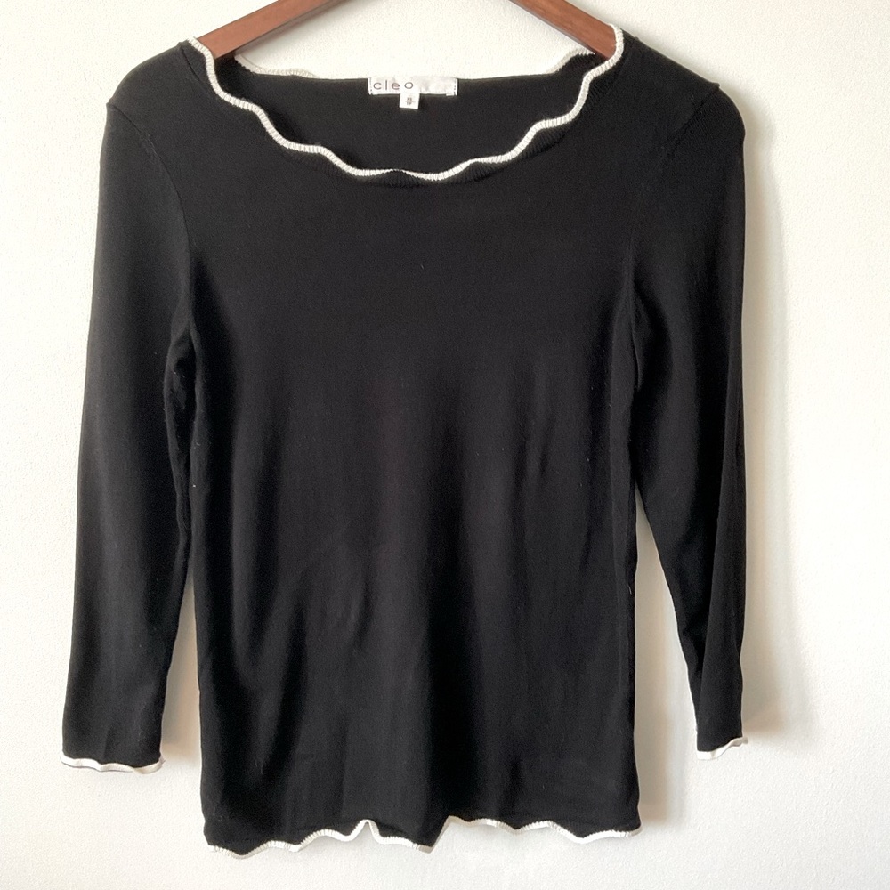 Black knit sweater with white lettuce neck and cuffs